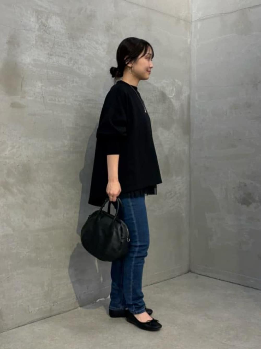 ブラック系のTシャツ/カットソー、ブラック系のキャミソール、ブルー系のデニムパンツを着用したレディースの夏コーディネートの6枚目の写真