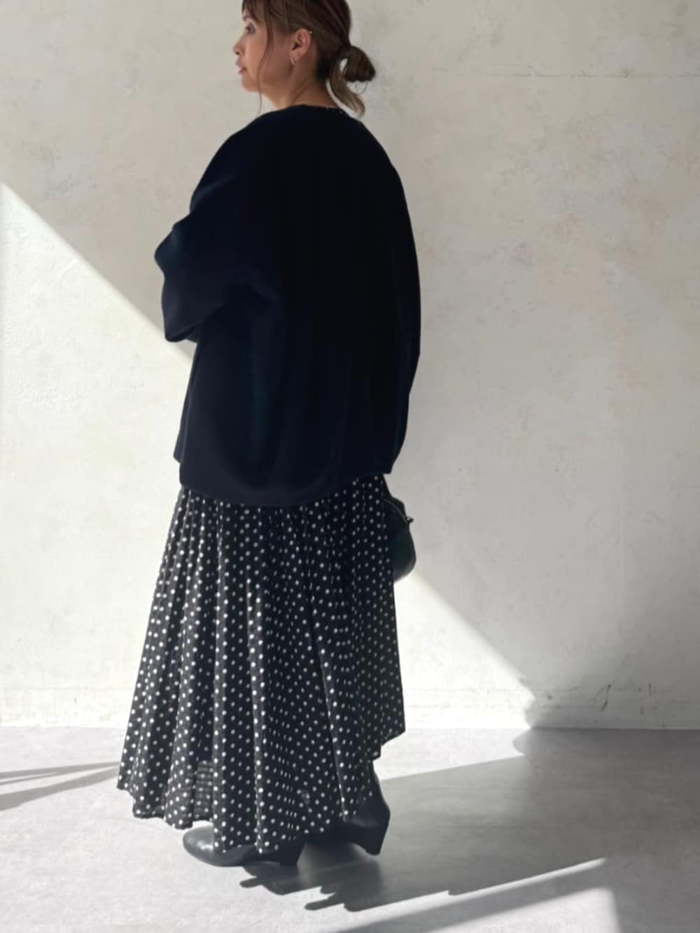 ブラック系のワンピース、ブルー系のノーカラーコートを着用したレディースの秋コーディネートの2枚目の写真