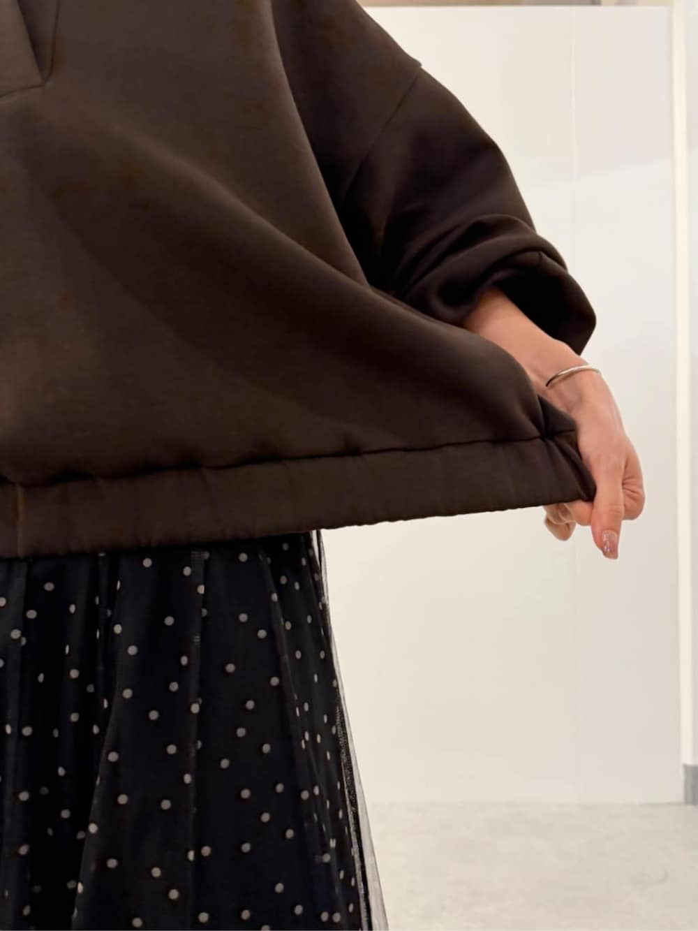 グレー系のハンドバッグ、ホワイト系のスカート、ブラウン系のTシャツ/カットソーを着用したレディースの夏コーディネートの9枚目の写真