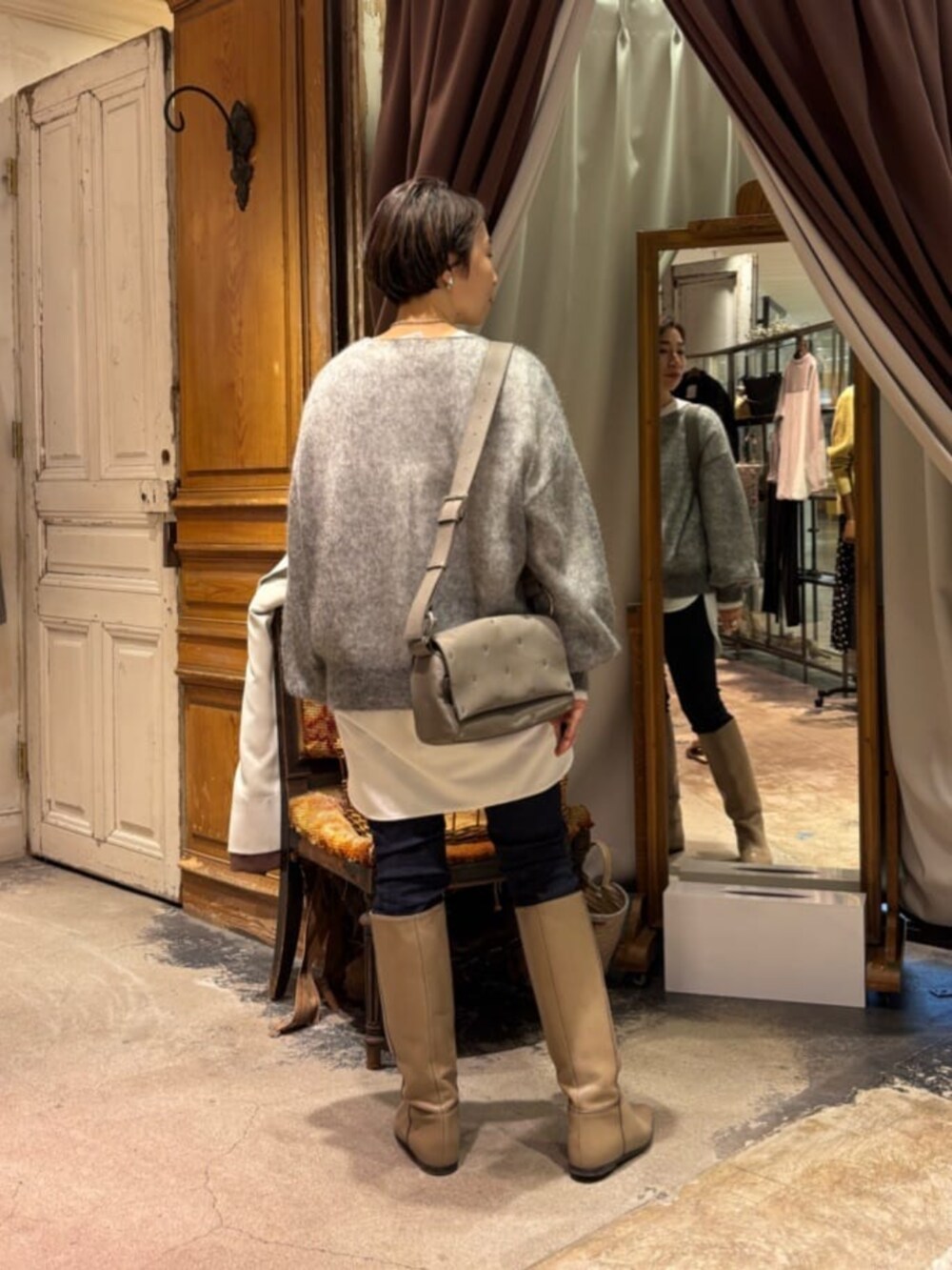 ホワイト系のシャツ/ブラウス、ブルー系のデニムパンツ、グレー系のショルダーバッグを着用したレディースの冬コーディネートの4枚目の写真