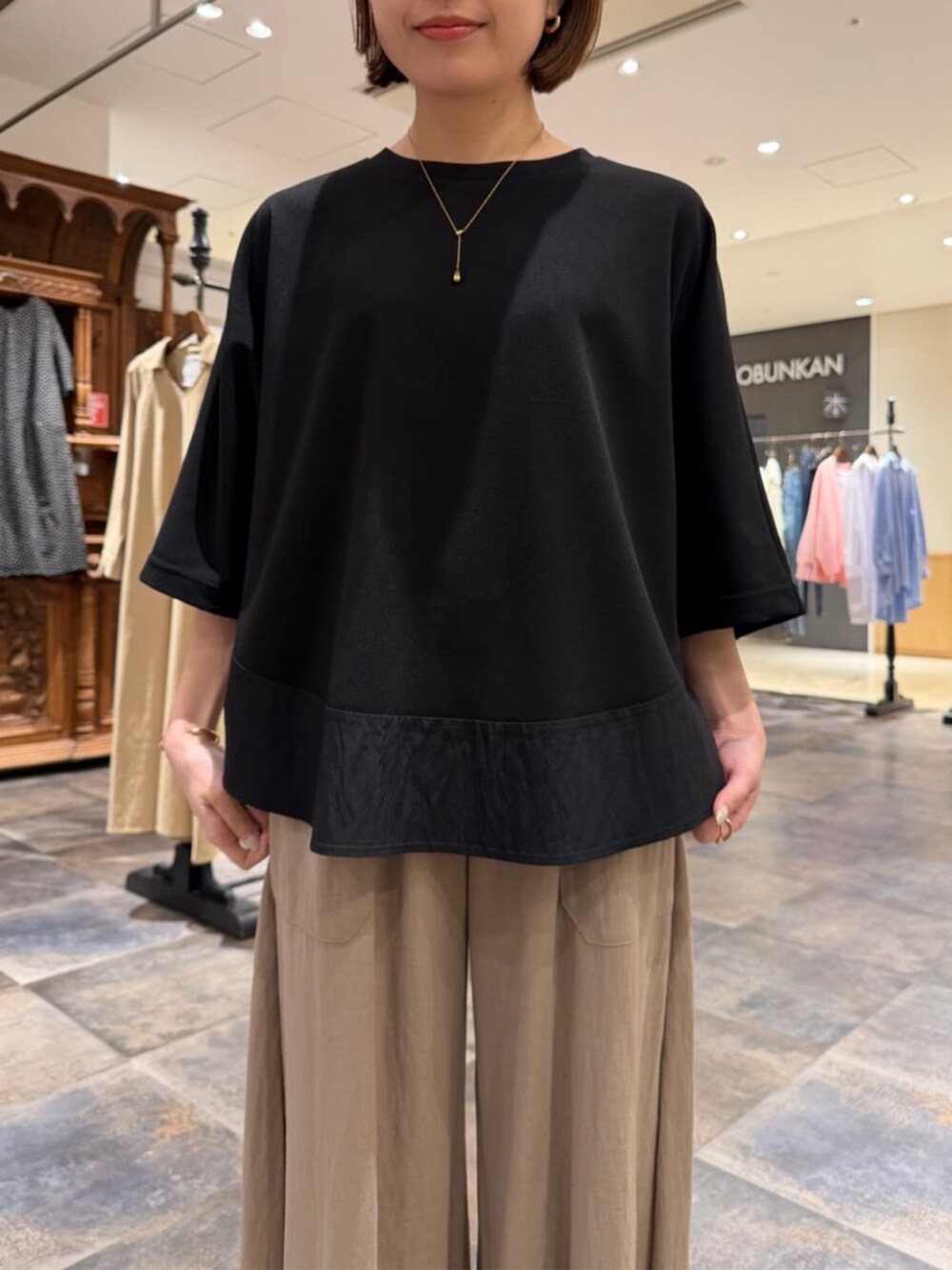 ベージュ系のその他パンツ、ブラック系のTシャツ/カットソーを着用したレディースの春コーディネートの4枚目の写真