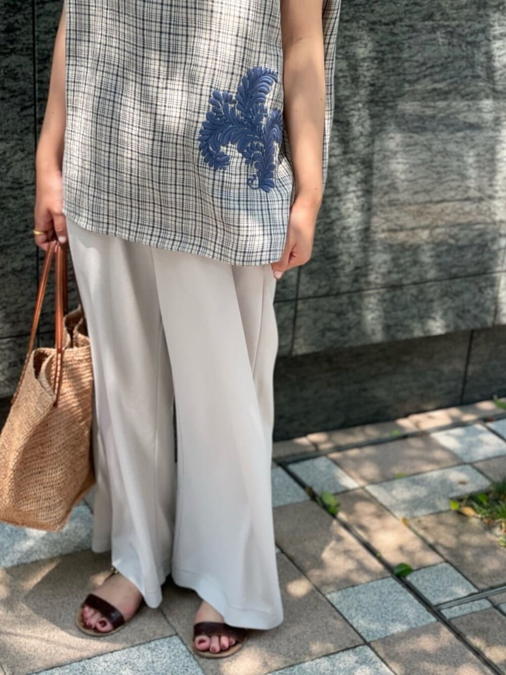 ブルー系のシャツ/ブラウス、グレー系のその他パンツ、ピンク系のかごバッグを着用したレディースの夏コーディネートの3枚目の写真