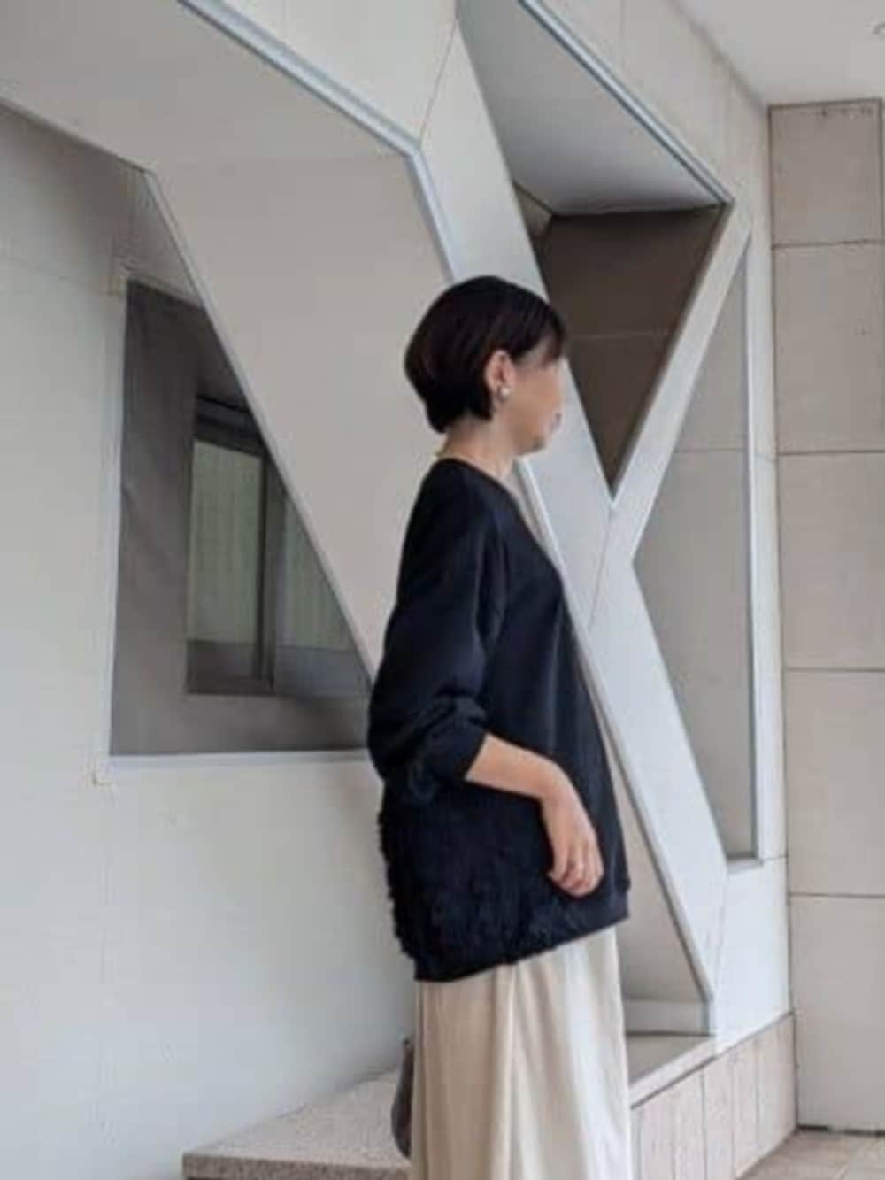 ベージュ系のスカート、ブラック系のTシャツ/カットソー、グレー系のトートバッグを着用したレディースの秋コーディネートの6枚目の写真