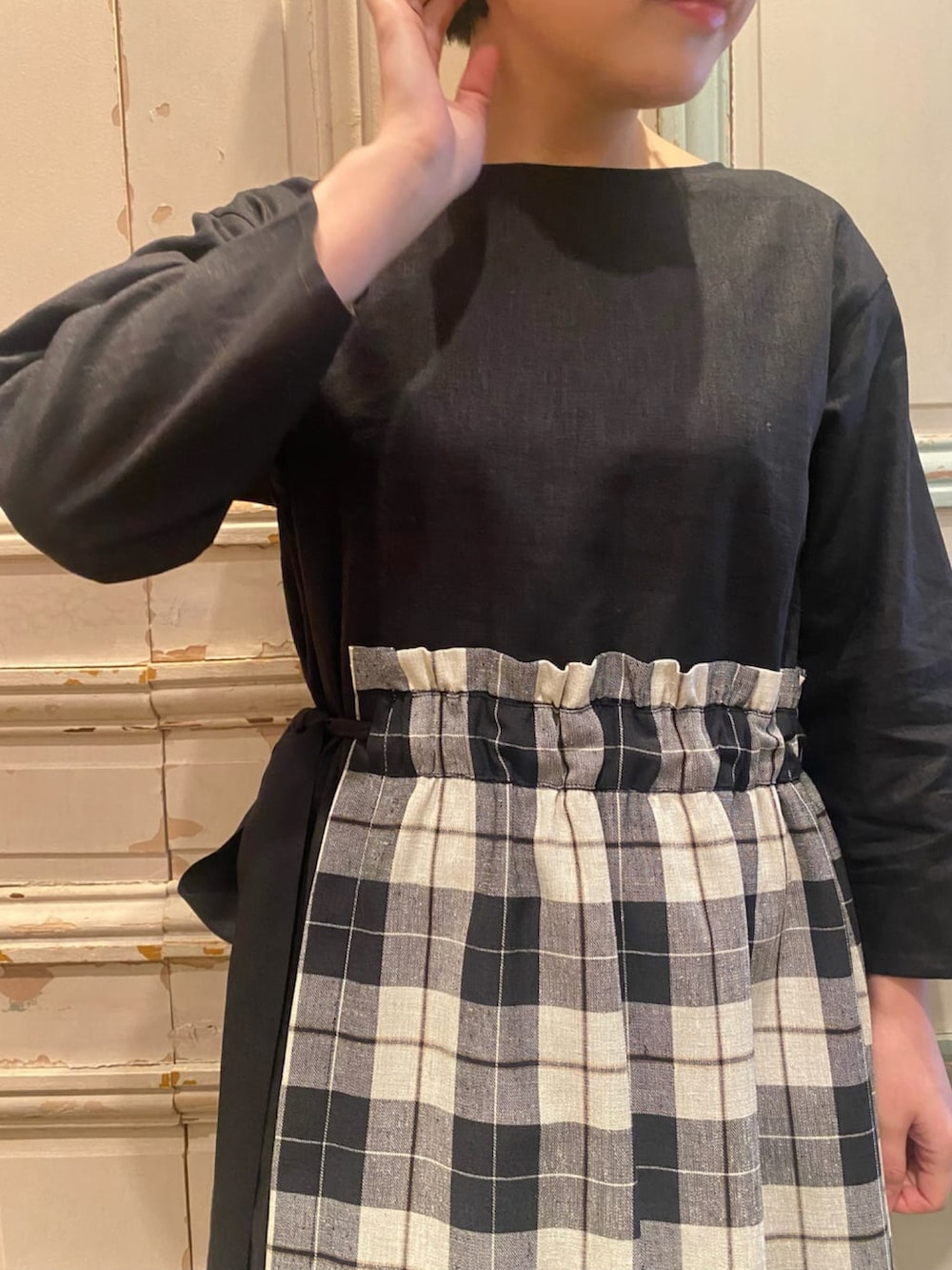 ブラック系のノーカラージャケット、ブラック系のワンピース、グリーン系のトートバッグを着用したレディースの春コーディネートの3枚目の写真