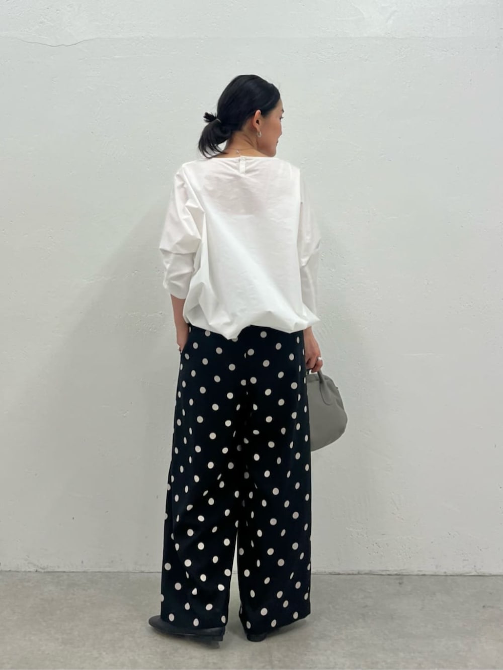 グレー系のボストンバッグ、ホワイト系のシャツ/ブラウス、ブラック系のその他パンツを着用したレディースの冬コーディネートの6枚目の写真