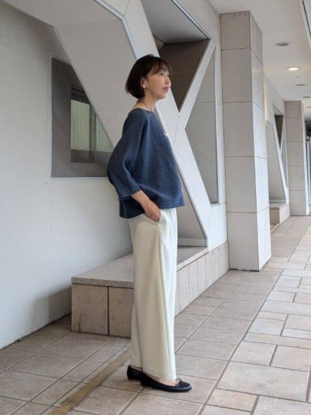 グレー系のショルダーバッグ、ホワイト系のその他パンツ、ブルー系のニット/セーターを着用したレディースの冬コーディネートの2枚目の写真