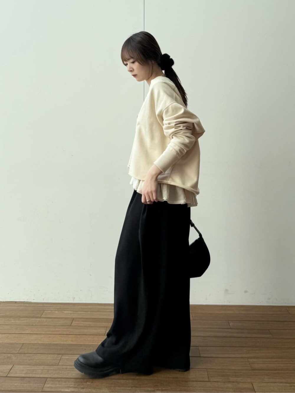 ブラック系のショルダーバッグ、ブラック系のその他パンツ、ホワイト系のキャミソールを着用したレディースの冬コーディネートの3枚目の写真