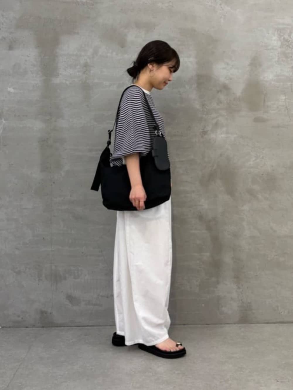 ブラック系のサンダル、ブラック系のショルダーバッグ、ホワイト系のその他パンツを着用したレディースの春コーディネートの3枚目の写真