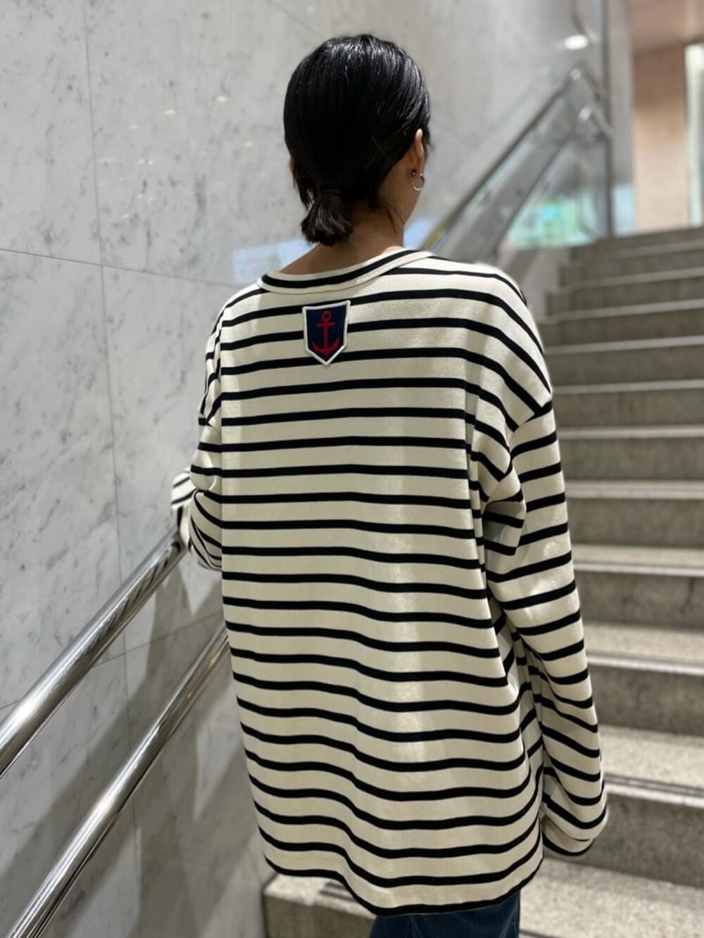 その他のブルゾン、ホワイト系のTシャツ/カットソー、ブルー系のその他パンツを着用したレディースの冬コーディネートの4枚目の写真