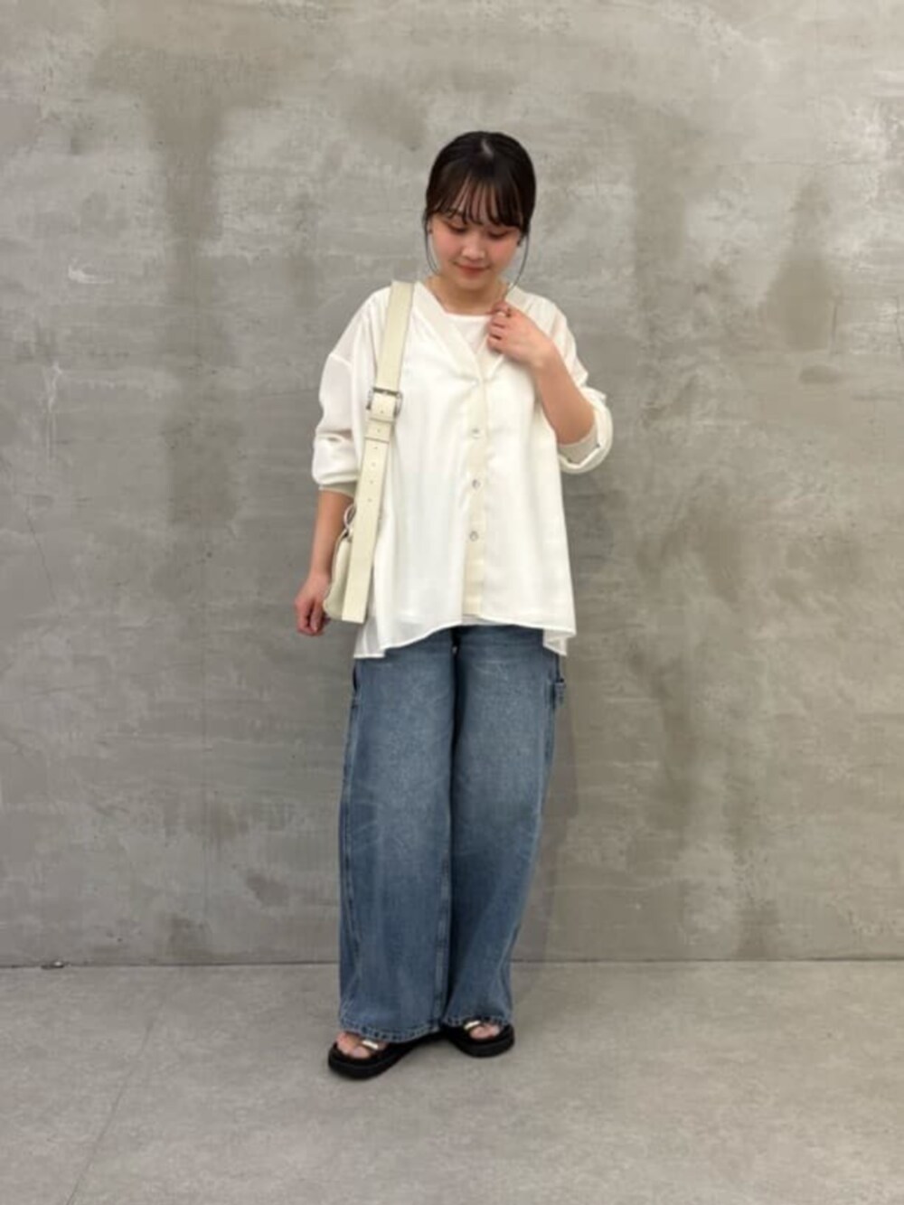 ホワイト系のショルダーバッグ、ブラック系のサンダル、ブルー系のその他パンツを着用したレディースの冬コーディネートの2枚目の写真