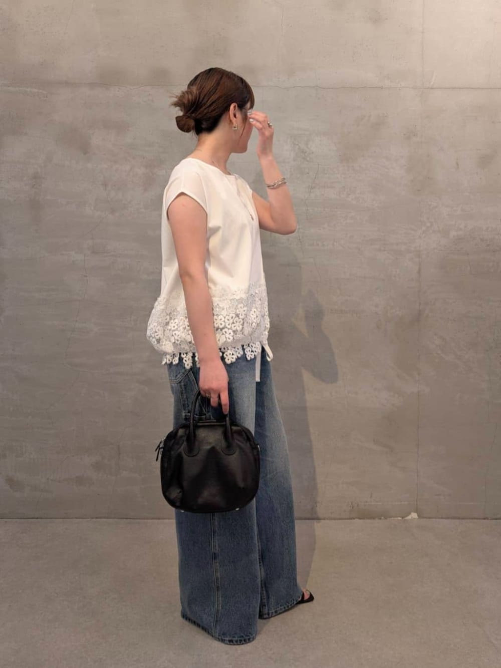 ブラック系のボストンバッグ、ブルー系のその他パンツ、ホワイト系のTシャツ/カットソーを着用したレディースの春コーディネートの2枚目の写真