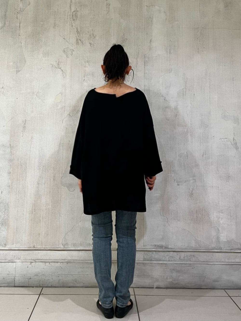 ブルー系のデニムパンツ、ブラック系のハンドバッグ、ブラック系のTシャツ/カットソーを着用したレディースの春コーディネートの6枚目の写真