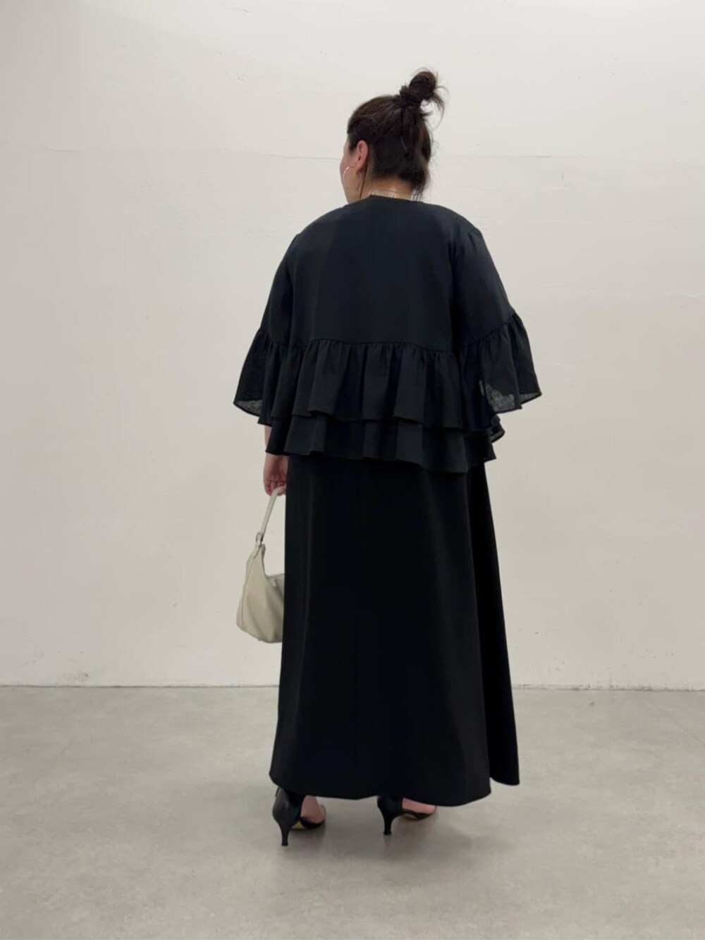 ブラック系のワンピース、ブラック系のその他アウターを着用したレディースの春コーディネートの4枚目の写真