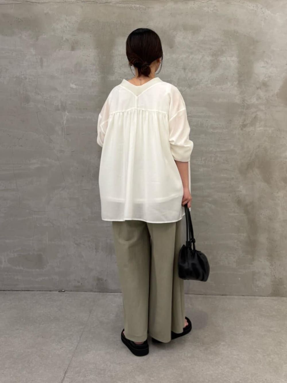 グリーン系のその他パンツ、ブラック系のサンダル、ホワイト系のシャツ/ブラウスを着用したレディースの冬コーディネートの3枚目の写真