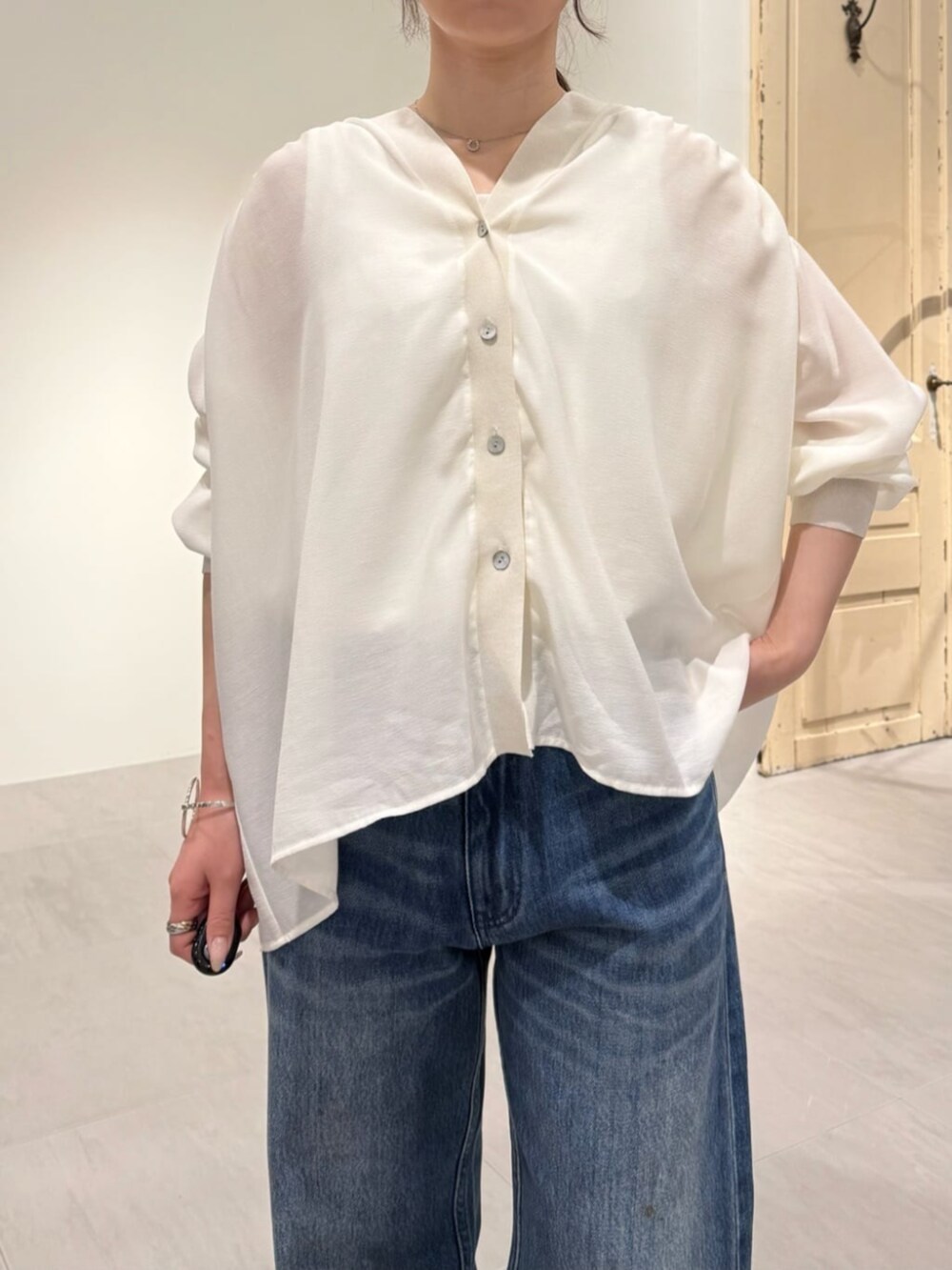 ホワイト系のシャツ/ブラウス、ブルー系のデニムパンツを着用したレディースの春コーディネートの6枚目の写真