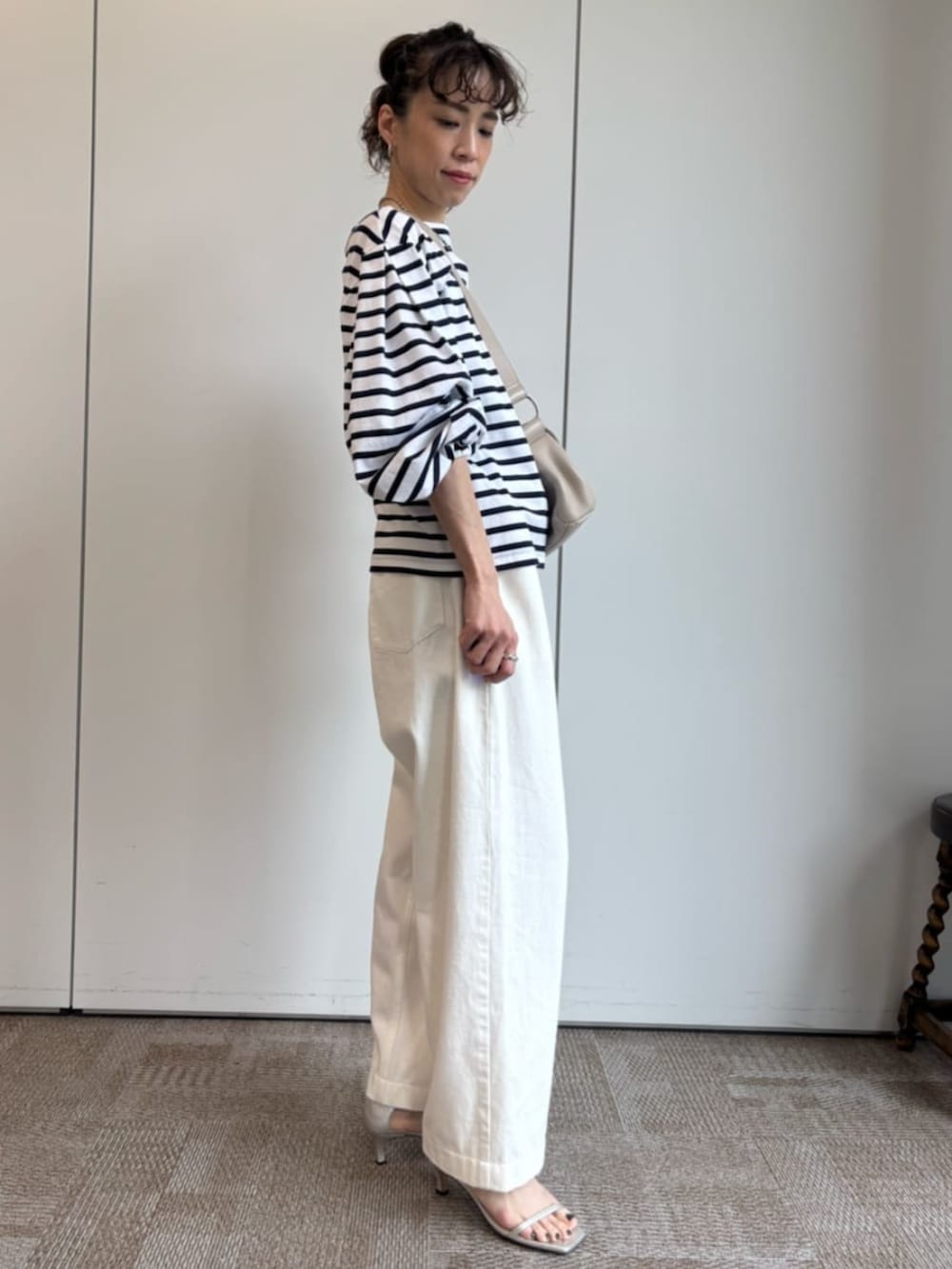 ベージュ系のショルダーバッグ、ホワイト系のTシャツ/カットソーを着用したレディースの冬コーディネートの4枚目の写真