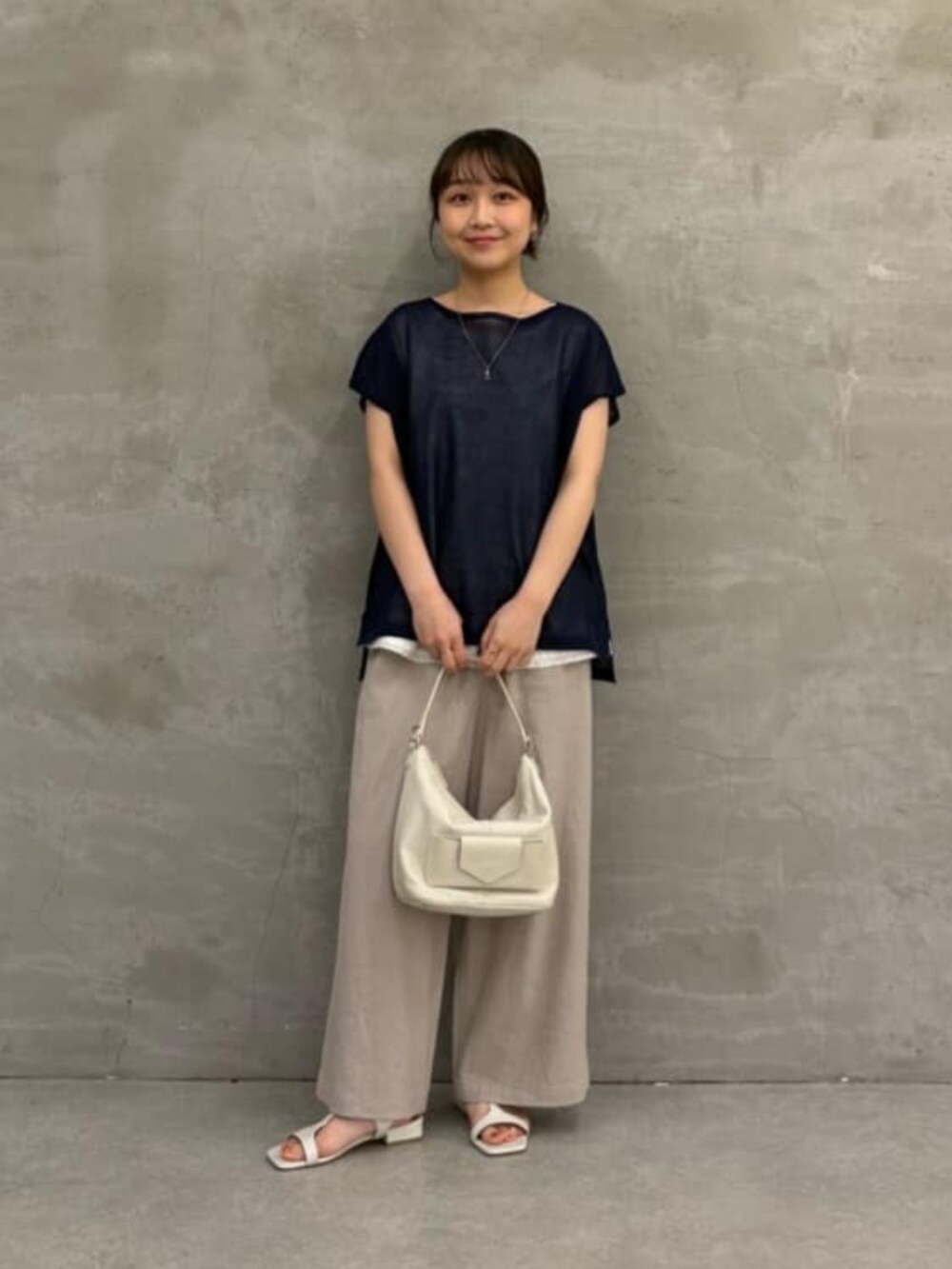 ホワイト系のトートバッグ、グレー系のその他パンツ、ブルー系のニット/セーターを着用したレディースの春コーディネートの4枚目の写真