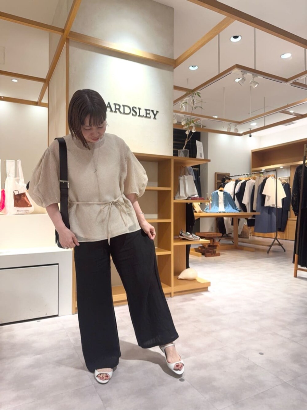 ベージュ系のシャツ/ブラウス、ブラック系のその他パンツを着用したレディースの春コーディネートの3枚目の写真