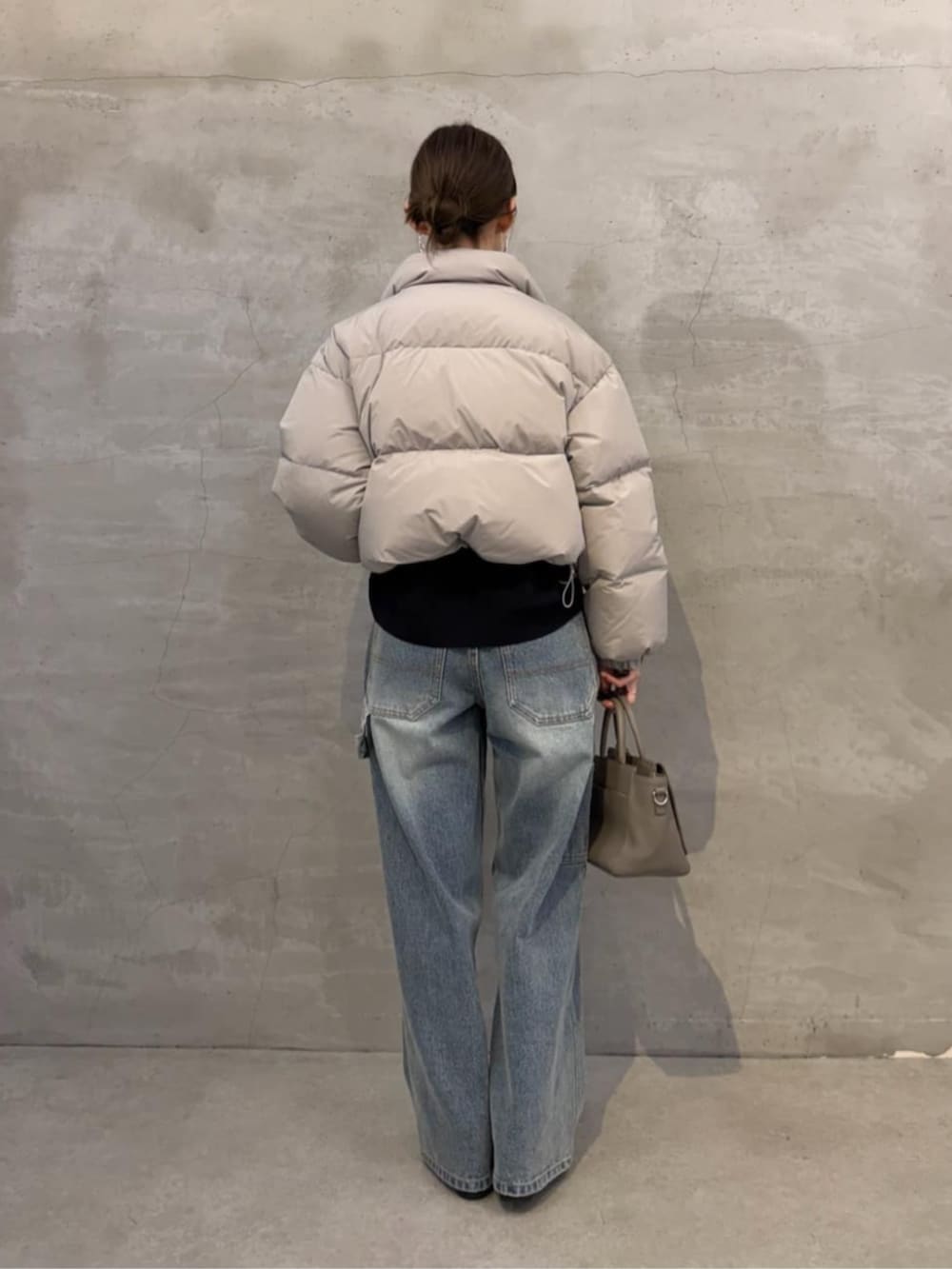 ブルー系のニット/セーター、ブルー系のデニムパンツ、グレー系のダウンジャケット/コートを着用したレディースの秋コーディネートの7枚目の写真
