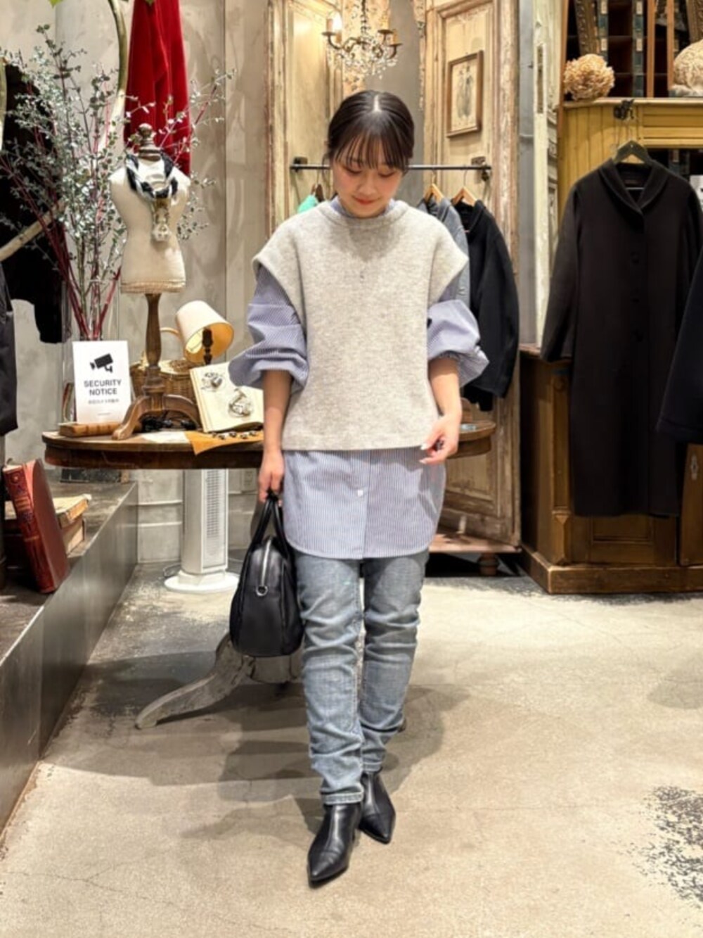 ブルー系のデニムパンツ、グレー系のシャツ/ブラウス、シルバー系のリングを着用したレディースの冬コーディネートの2枚目の写真