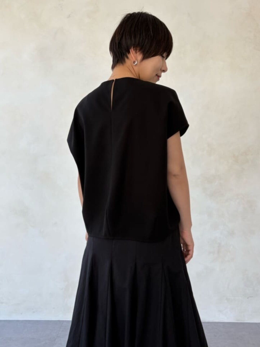 グレー系のハンドバッグ、ブラック系のシャツ/ブラウス、ブラック系のスカートを着用したレディースの春コーディネートの7枚目の写真