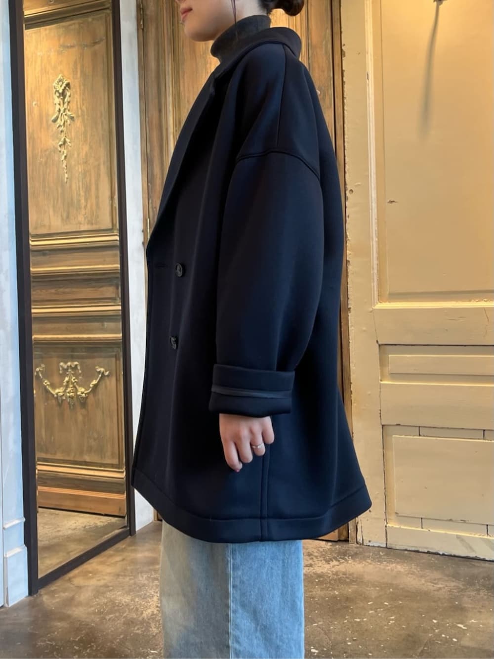 グレー系のニット/セーター、ブルー系のピーコートを着用したレディースの冬コーディネートの6枚目の写真