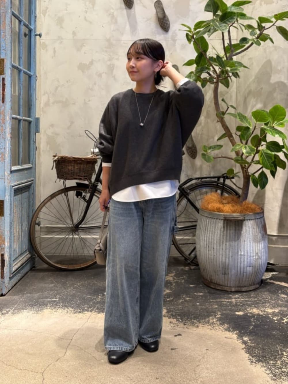 ホワイト系のシャツ/ブラウス、ブルー系のデニムパンツ、シルバー系のトートバッグを着用したレディースの夏コーディネートの2枚目の写真