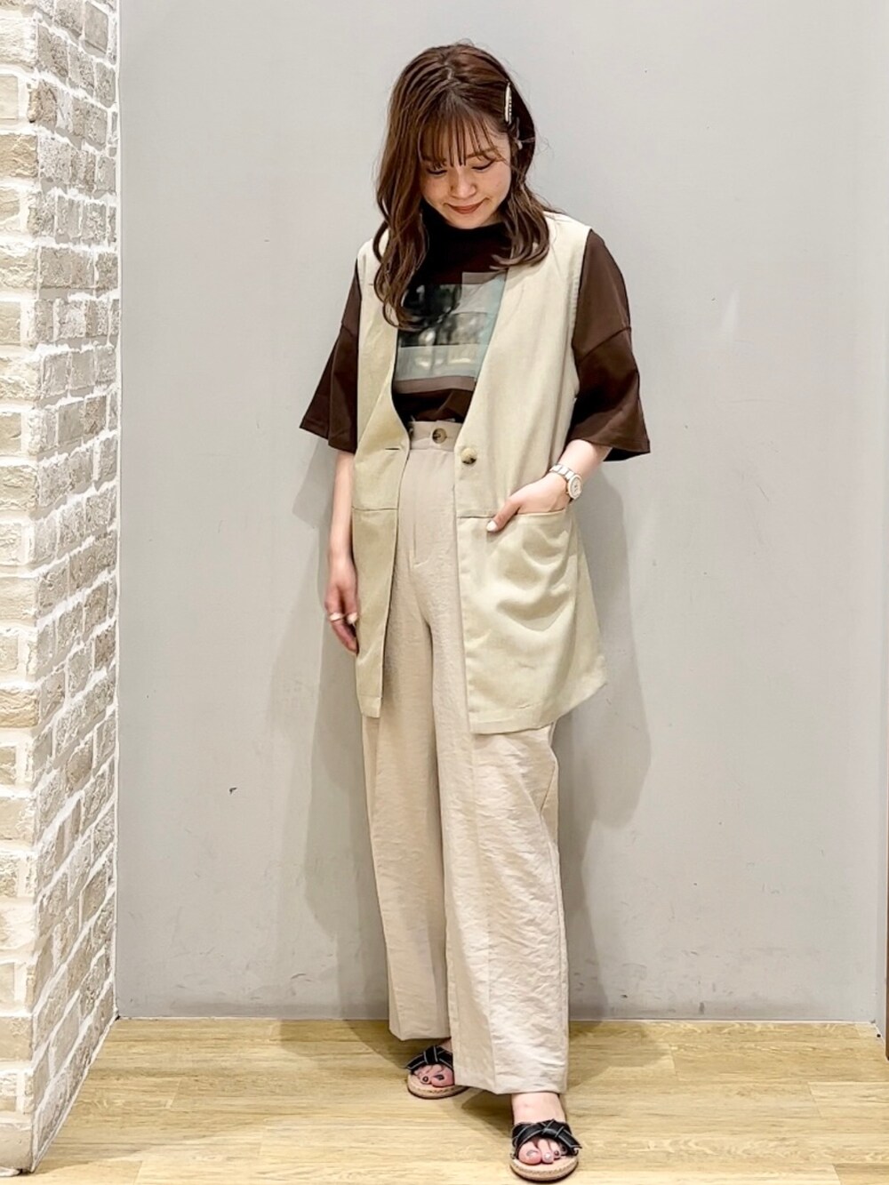 ブラック系のサンダル、ベージュ系のその他パンツ、ベージュ系のベストを着用したレディースの夏コーディネートの2枚目の写真