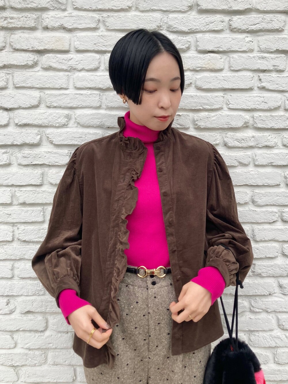 ブラック系のトートバッグ、ブラウン系のその他パンツ、ピンク系のニット/セーターを着用したレディースの冬コーディネートの2枚目の写真