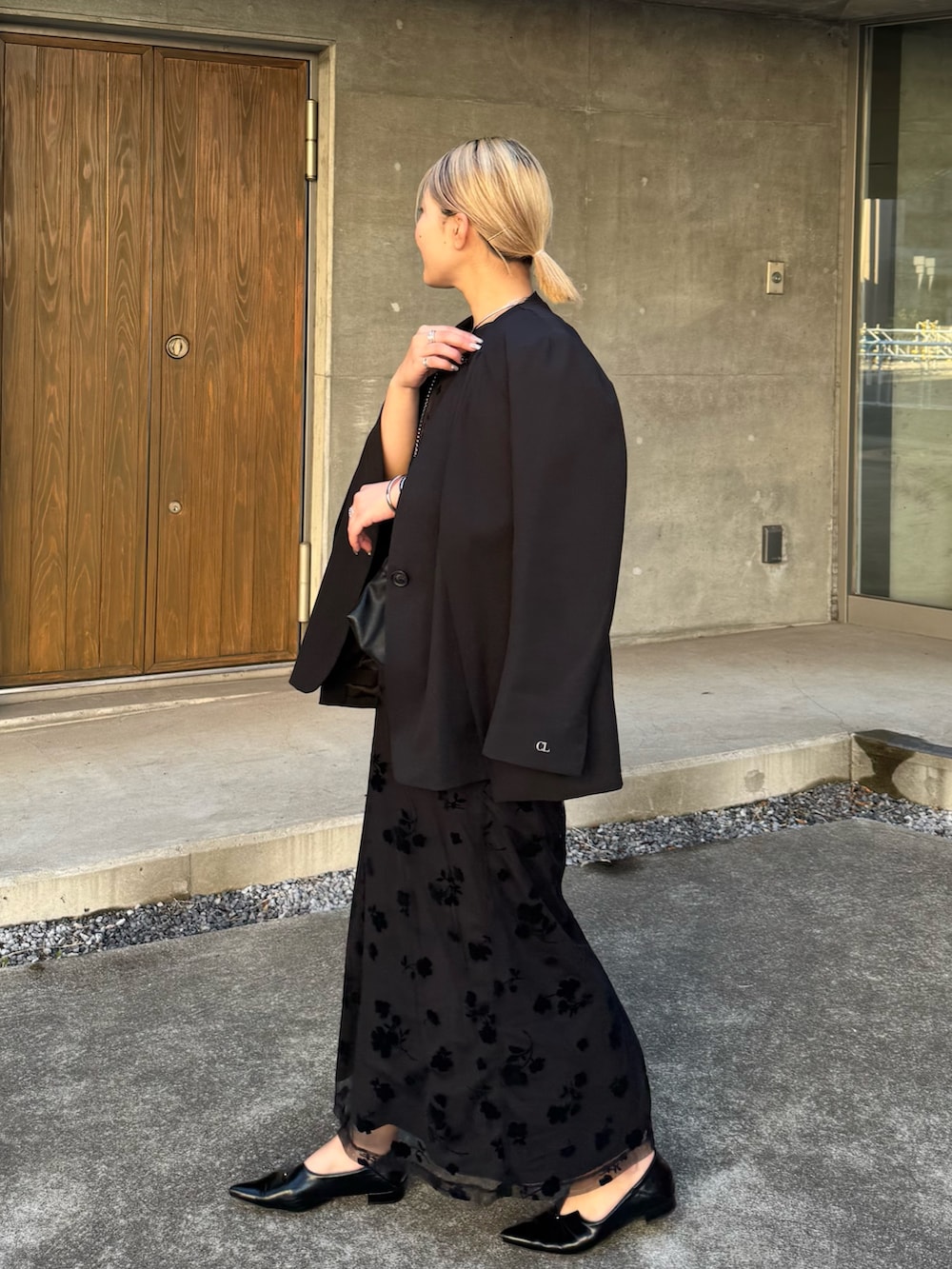 ブラック系のショルダーバッグ、ブラック系のワンピース、ブラック系のテーラードジャケットを着用したレディースの冬コーディネートの3枚目の写真