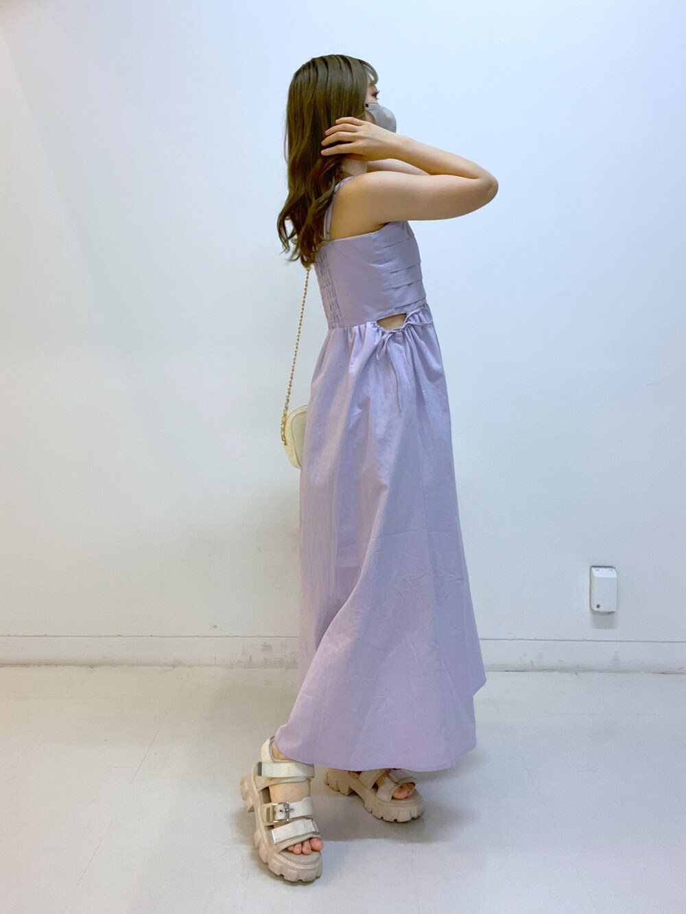 パープル系のワンピース、ホワイト系のショルダーバッグを着用したレディースの夏コーディネートの3枚目の写真