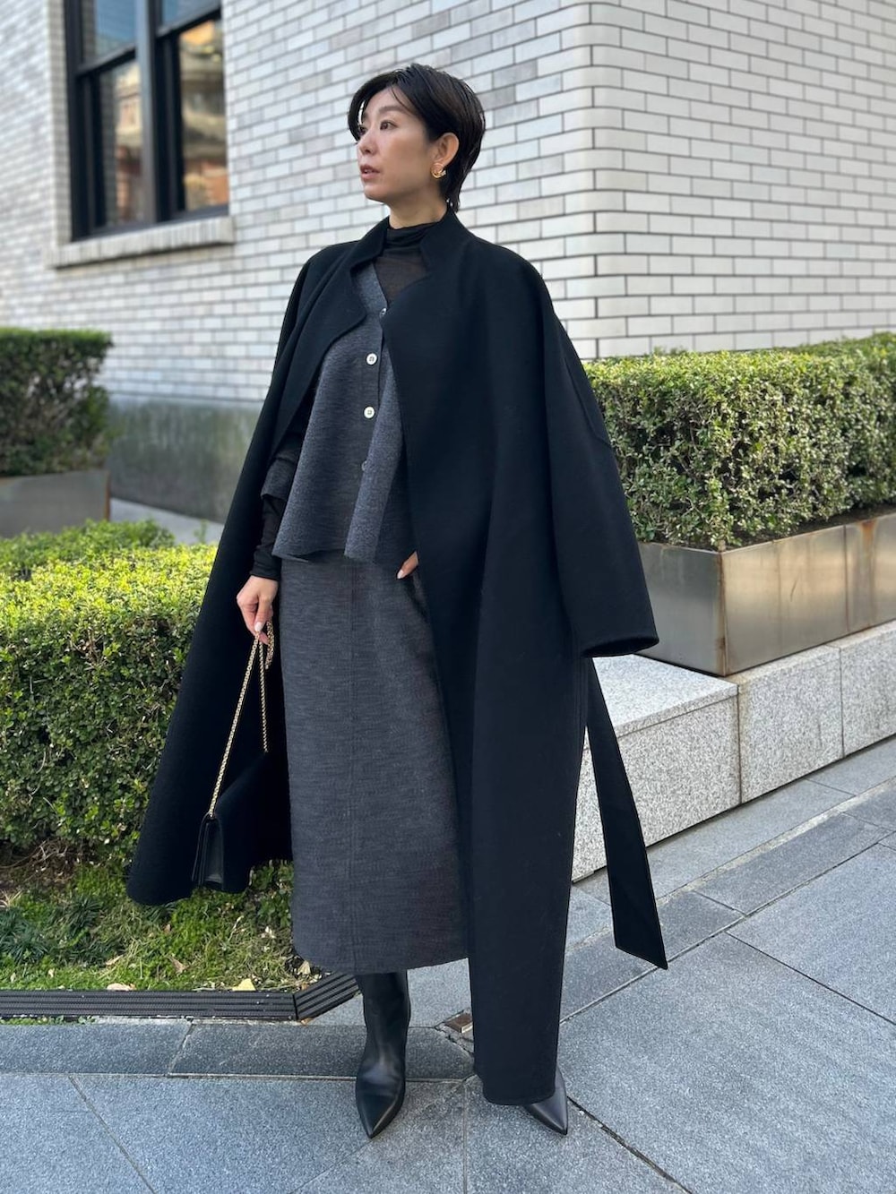 ブラック系のその他トップス、ブラック系のノーカラーコート、グレー系のカーディガン/ボレロを着用したレディースの秋コーディネートの8枚目の写真