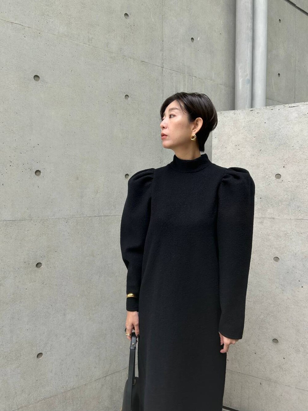 ブラック系のワンピースを着用したレディースの秋コーディネートの7枚目の写真