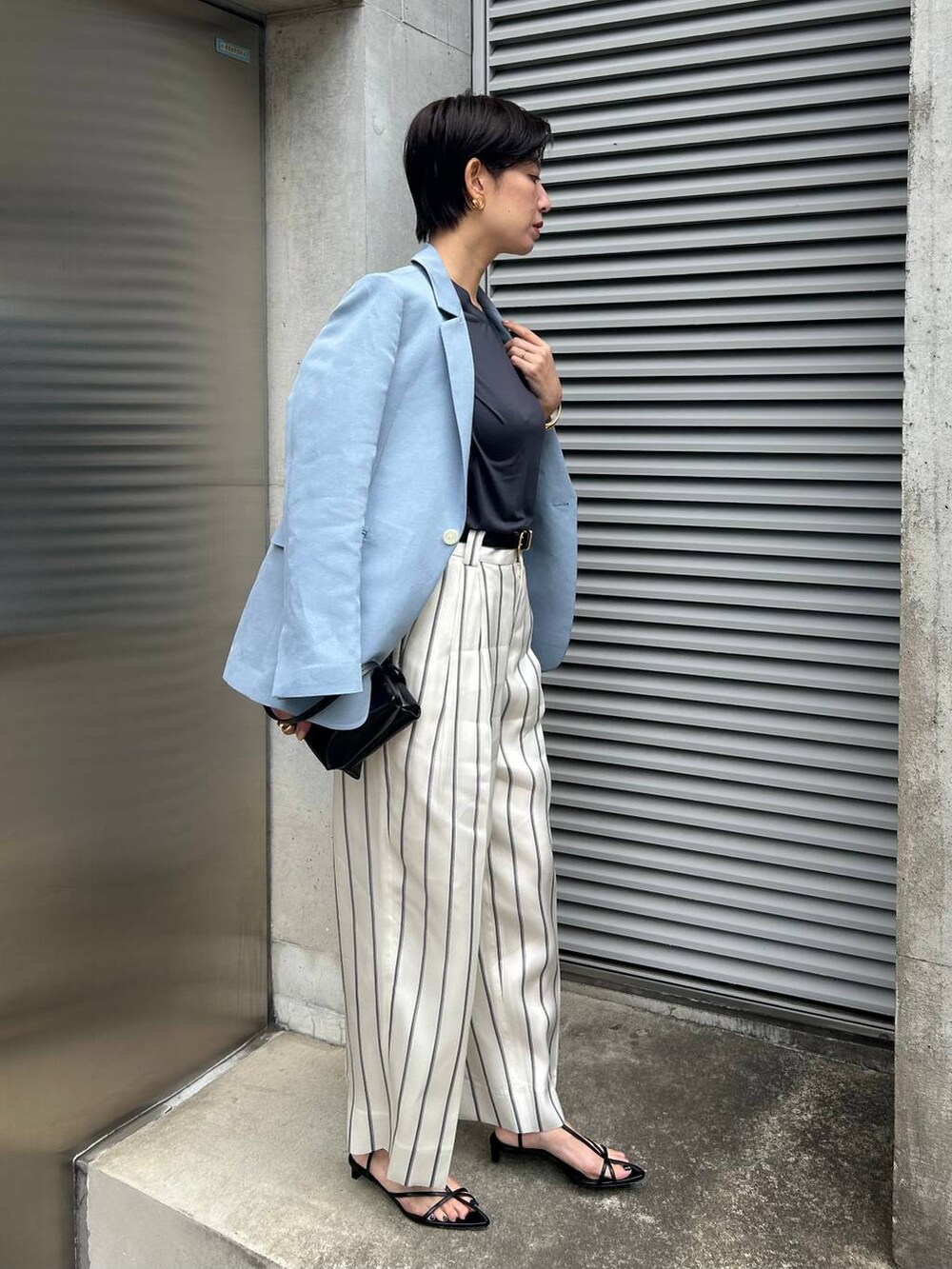 ホワイト系のスラックス、ブルー系のTシャツ/カットソー、ブルー系のテーラードジャケットを着用したレディースの春コーディネートの2枚目の写真