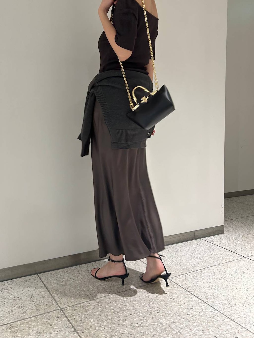 グリーン系のカーディガン/ボレロ、グリーン系のスカート、ブラウン系のTシャツ/カットソーを着用したレディースの春コーディネートの7枚目の写真