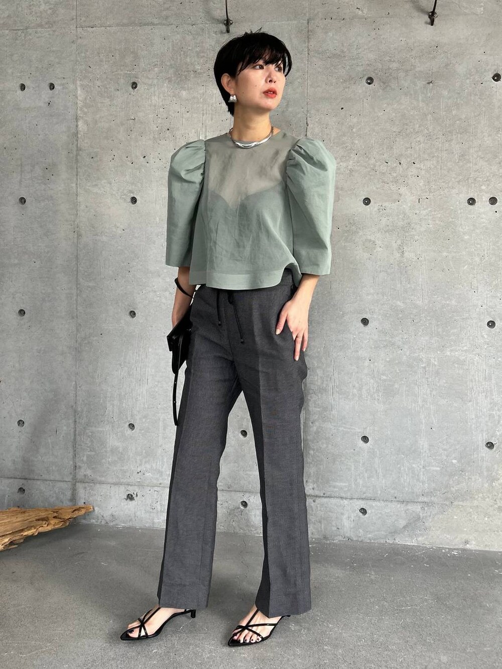 ブラック系のその他パンツ、グリーン系のシャツ/ブラウスを着用したレディースの春コーディネートの2枚目の写真
