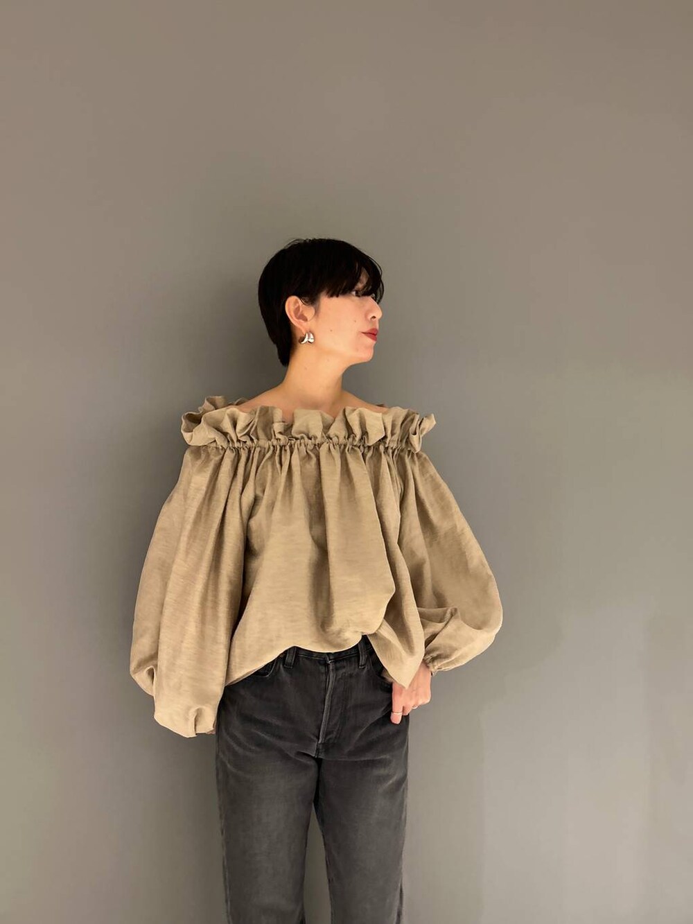 ブラック系のデニムパンツ、ベージュ系のシャツ/ブラウスを着用したレディースの冬コーディネートの4枚目の写真