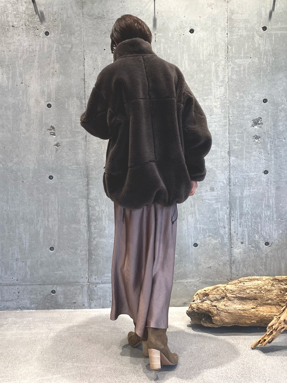 ブラウン系のジャケット/アウター、ブラウン系のスカート、ブラック系のニット/セーターを着用したレディースの秋コーディネートの2枚目の写真