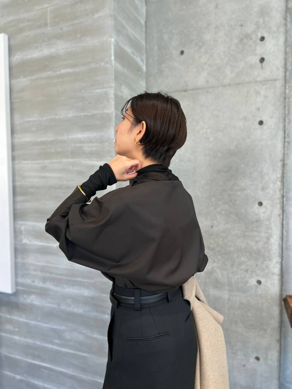 ブラック系のその他トップス、グレー系のノーカラーコート、ブラック系のベルトを着用したレディースの秋コーディネートの7枚目の写真