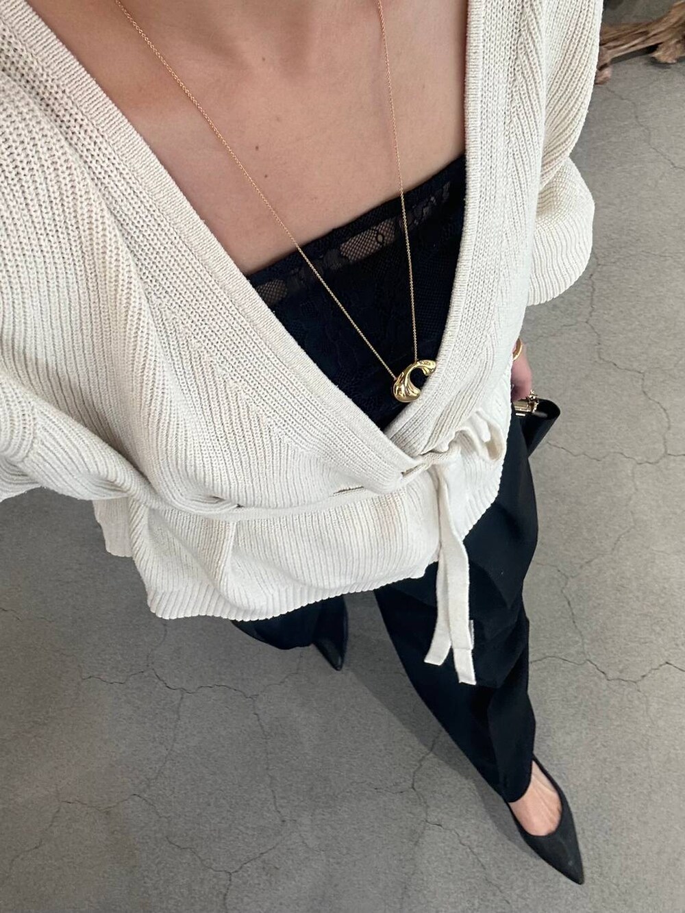 ブラック系のその他トップス、ホワイト系のカーディガン/ボレロ、ブラック系のスラックスを着用したレディースの冬コーディネートの6枚目の写真