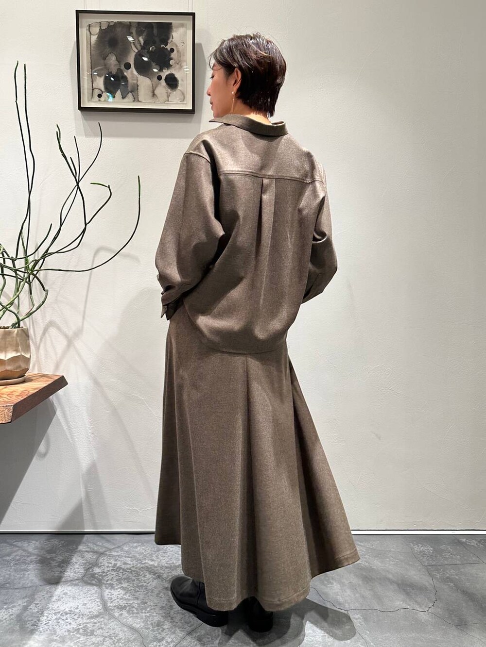 ブルー系のカーディガン/ボレロ、ブラック系のブーツ、ブラウン系のスカートを着用したレディースの冬コーディネートの6枚目の写真