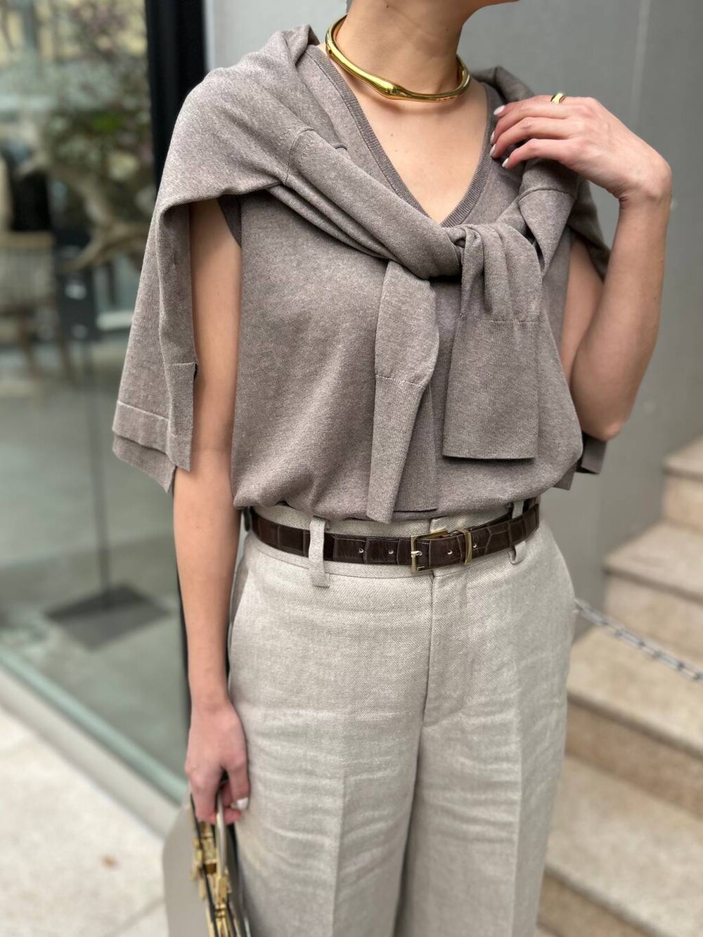 ホワイト系のスラックス、ブラウン系のニット/セーター、ブラウン系のカーディガン/ボレロを着用したレディースの春コーディネートの6枚目の写真