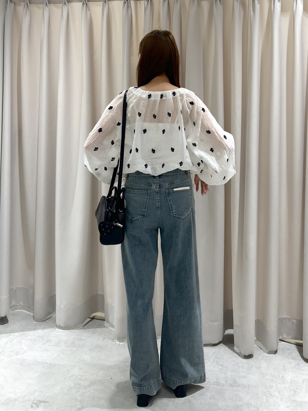 ブルー系のデニムパンツ、ホワイト系のシャツ/ブラウス、ブラック系のサンダルを着用したレディースの夏コーディネートの3枚目の写真