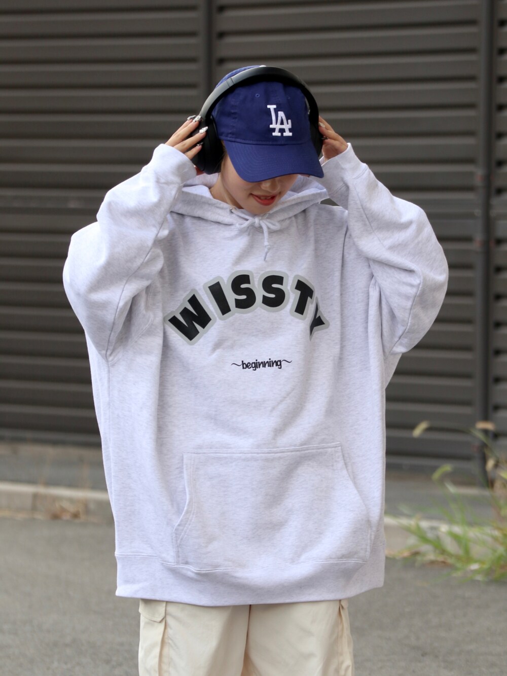 グレー系のスウェット、ホワイト系のカーゴパンツを着用したレディースの秋コーディネートの2枚目の写真