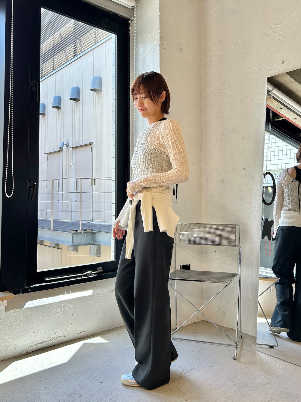 ブラック系のタンクトップ、ホワイト系のカーディガン/ボレロを着用したレディースの夏コーディネートの3枚目の写真