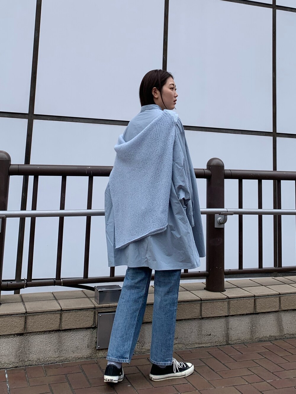 ブルー系のシャツ/ブラウス、ブルー系のニット/セーター、ブルー系のデニムパンツを着用したレディースの春コーディネートの3枚目の写真