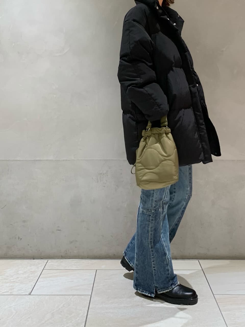 ブラック系のダウンジャケット/コート、ブルー系のデニムパンツを着用したレディースの秋コーディネートの2枚目の写真