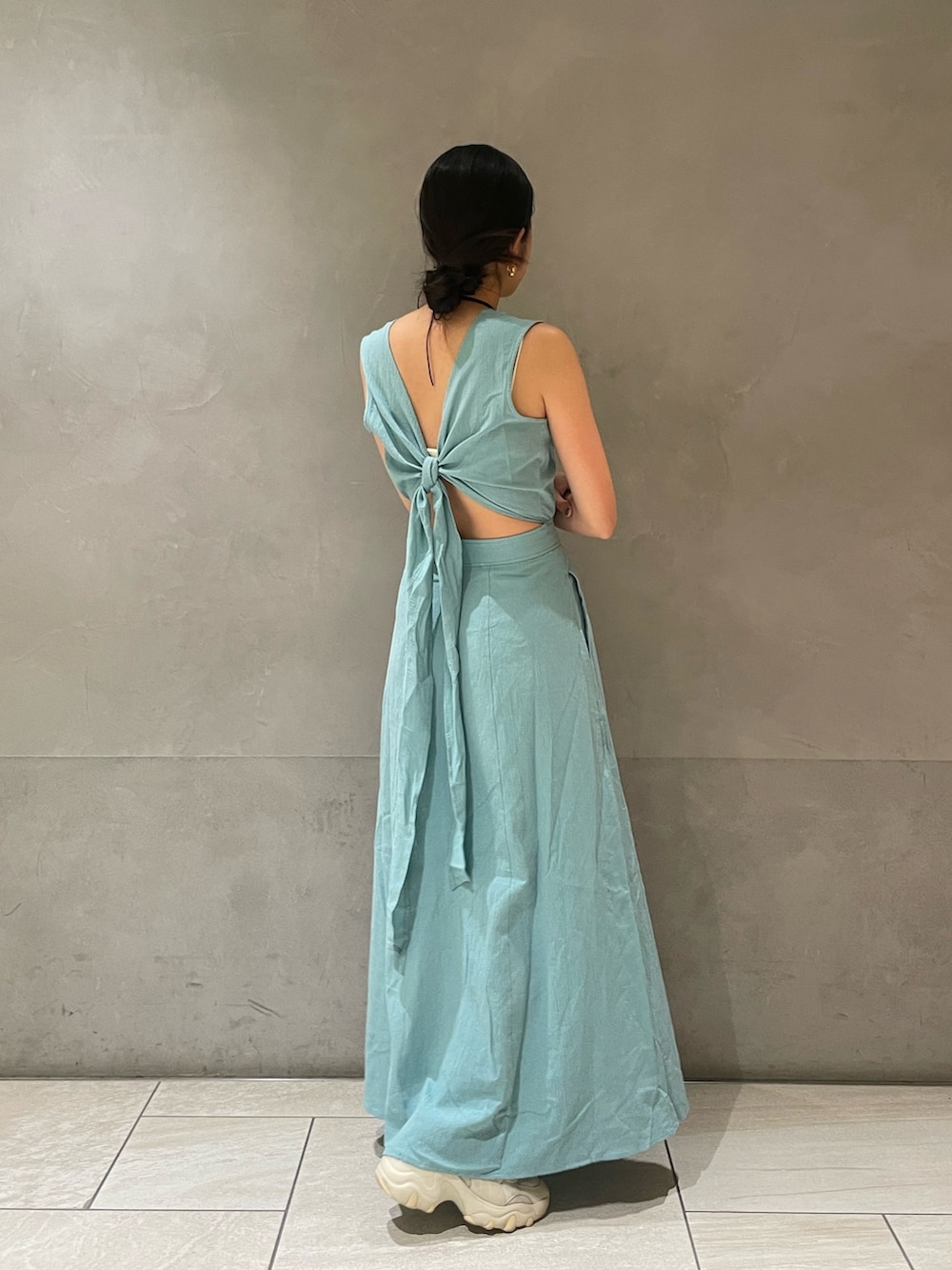 ブルー系のワンピース、ゴールド系のネックレスを着用したレディースの春コーディネートの4枚目の写真