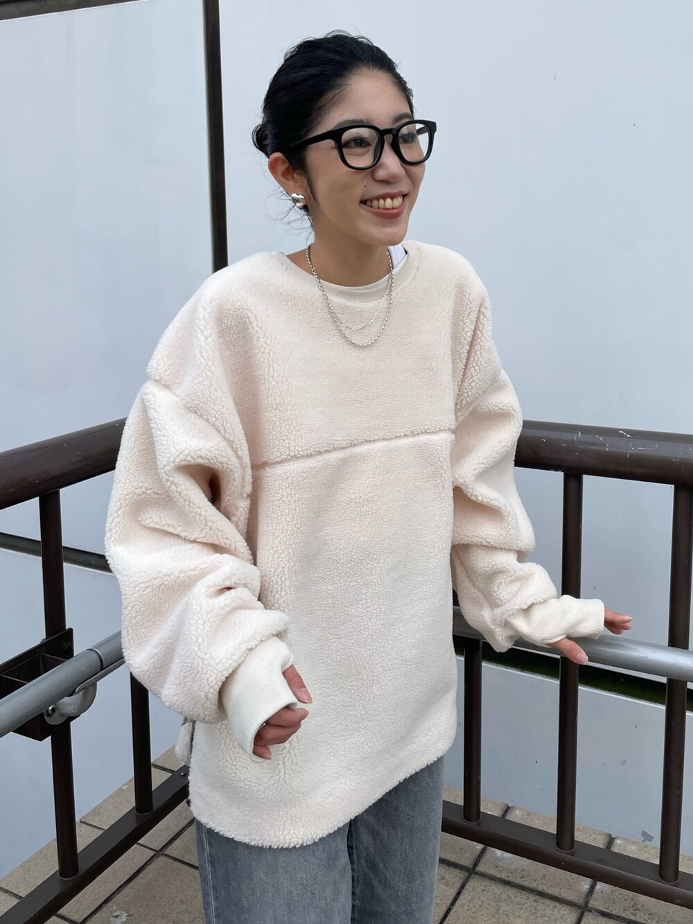 ホワイト系のTシャツ/カットソー、ブラック系のデニムパンツ、ベージュ系のブーツを着用したレディースの秋コーディネートの4枚目の写真