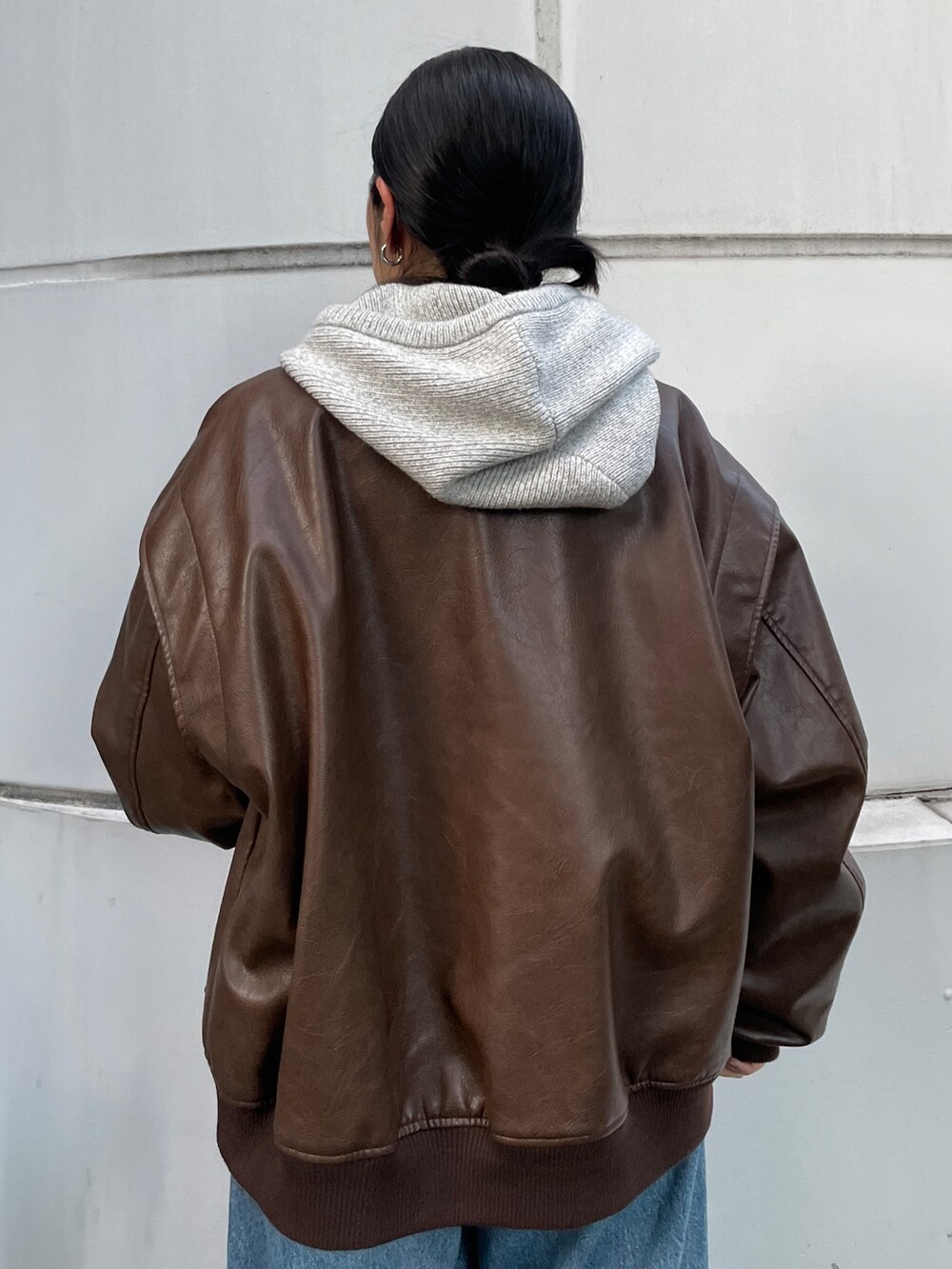 ブルー系のデニムパンツ、ブラウン系のブルゾン、ブラウン系のブーツを着用したレディースの秋コーディネートの6枚目の写真